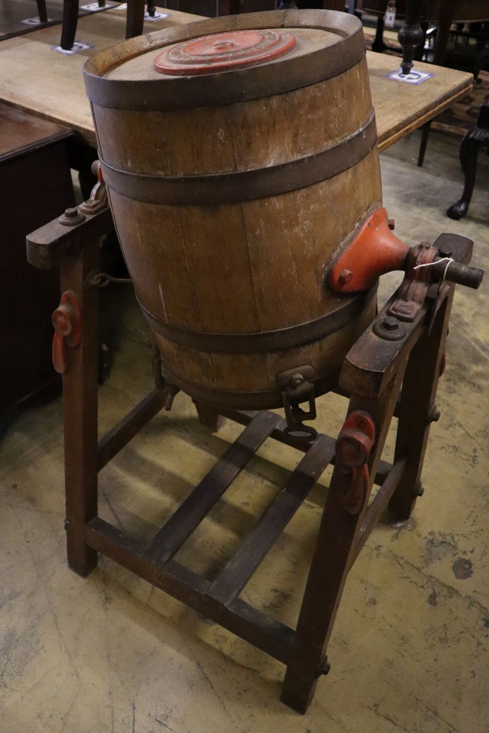 An early 20th century butter churn and two butter pats, width 64cm height 103cm